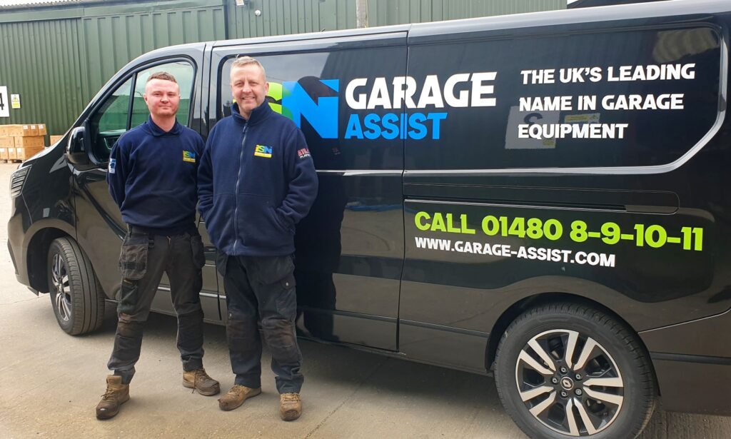2 engineers standing by an ISN Garage Assist vehicle